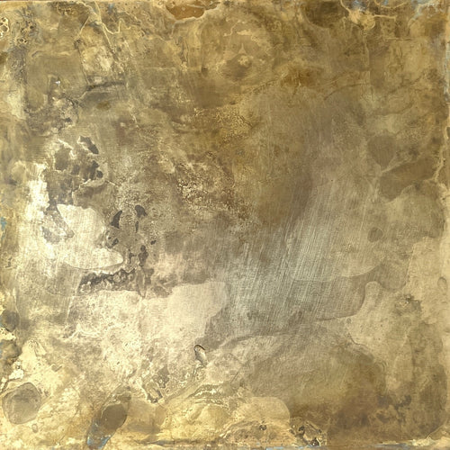 Close-up image of a aged brass sheet, flickering golden light and clouds of dark patina
