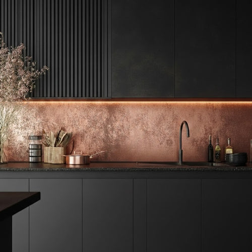 Copper splashback installed in a dark moody kitchen, with black mate cabinets and black marble worktop