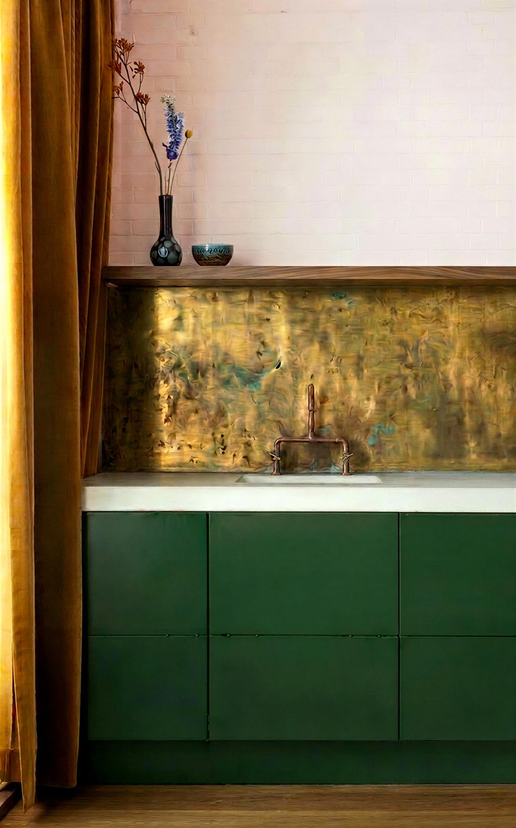 Kitchen with green cabinets, brass backsplash, oak shelve and decorative elements.

